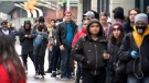 Customers line up outside EB Game on Yonge Street on Friday, March 20, 2020.
