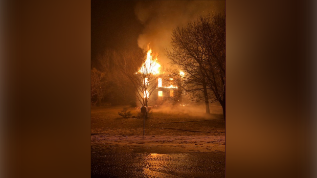 A house is shown engulfed in flames after a fire that began on Monday morning in West Perth. (Courtesy: @OPP_WR)