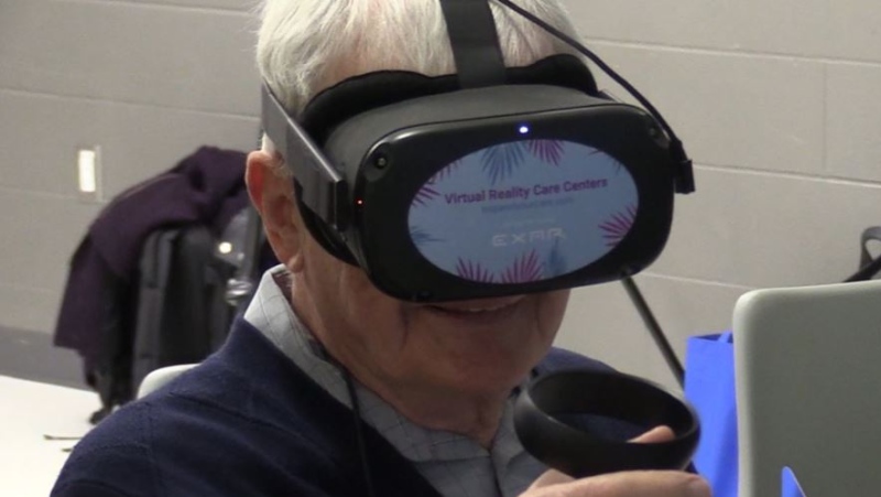 A client from the Alzheimer's Society of London-Middlesex uses a virtual reality device to take a walk on the beach on Monday, March 23, 2020. (Celine Zadorsky / CTV London)