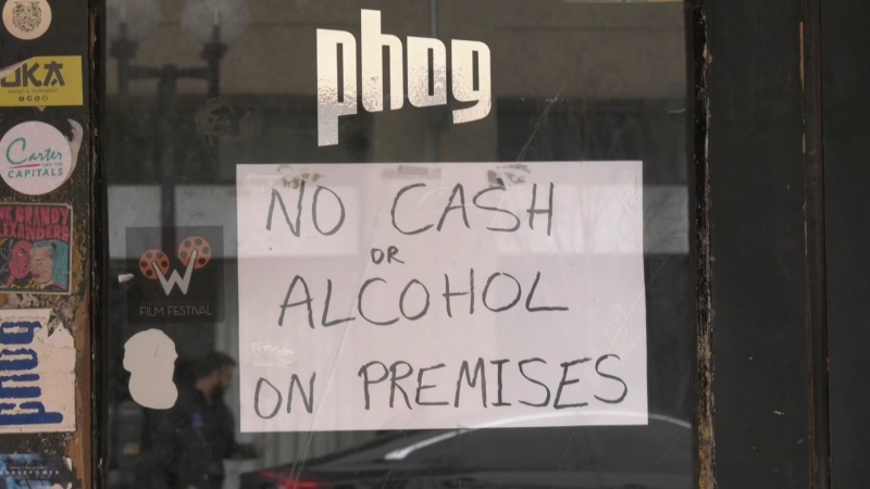 A sign in the window of a business in Windsor, Ont. is aimed at deterring thieves on Tuesday, March 24, 2020. (Rich Garton / CTV Windsor)