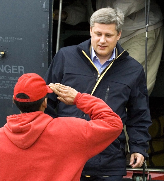Prime Minister Stephen Harper is saluted by an Arctic Rangers as he arrives in Resolute Bay, August 10, 2007. (CP / Fred Chartrand)