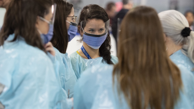 Medical staff prepare for the opening of the COVID-19 Assessment Centre at Brewer Park Arena in Ottawa, during a media tour on Friday, March 13, 2020. THE CANADIAN PRESS/Justin Tang