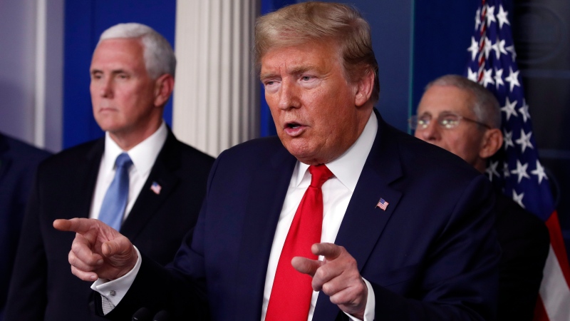 U.S. President Donald Trump speaks about the coronavirus in the James Brady Briefing Room, Tuesday, March 24, 2020, in Washington, as Vice President Mike Pence and Dr. Anthony Fauci, director of the National Institute of Allergy and Infectious Diseases, listen. (AP Photo/Alex Brandon)