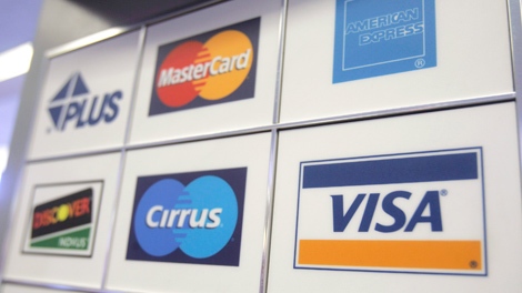 A VISA credit card sign is posted with other credit card companies at an ATM bank machine in San Jose, Calif., Sunday, March 16, 2008. (AP / Paul Sakuma) 