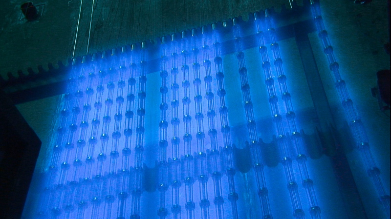 Cobalt rods harvested from a Bruce Power reactor are staged underwater before being disassembled into individual bundles for shipping. The water provides cooling and radiological shielding. Cobalt-60 glows blue underwater, which is known as the Cherenkov effect. 