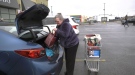 LCBO customer loading wine into her car, delivering to seniors at risk. Ottawa, ON. March 26, 2020. (Tyler Fleming / CTV News Ottawa)