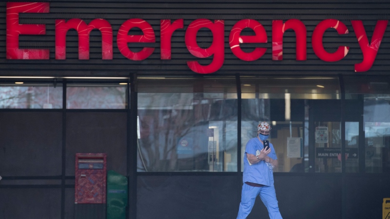 A health care worker is seen outside the Emergency dept. of the Vancouver General Hospital in Vancouver Monday, March 30, 2020. THE CANADIAN PRESS/Jonathan Hayward