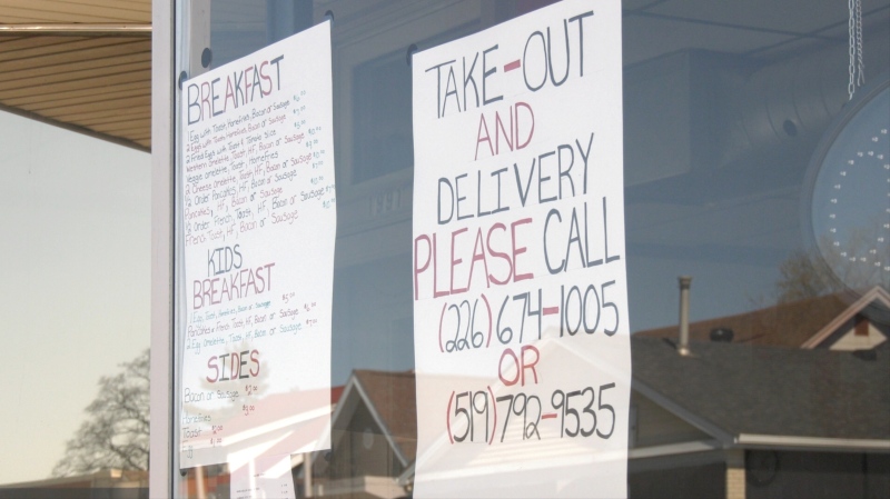 Generations Diner on Ottawa Street tapes a poster to the front window indicating its takeout options, as a result of a provincial order to close in an effort to prevent the spread of COVID-19. April 2, 2020. (Ricardo Veneza / CTV Windsor)