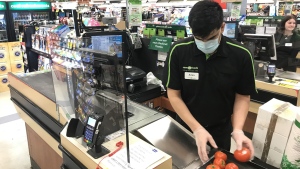 A plexiglass barrier is pictured creating a barrier to protect a cashier at a grocery store in North Vancouver, B.C. Sunday, March 22, 2020. (THE CANADIAN PRESS / Jonathan Hayward)