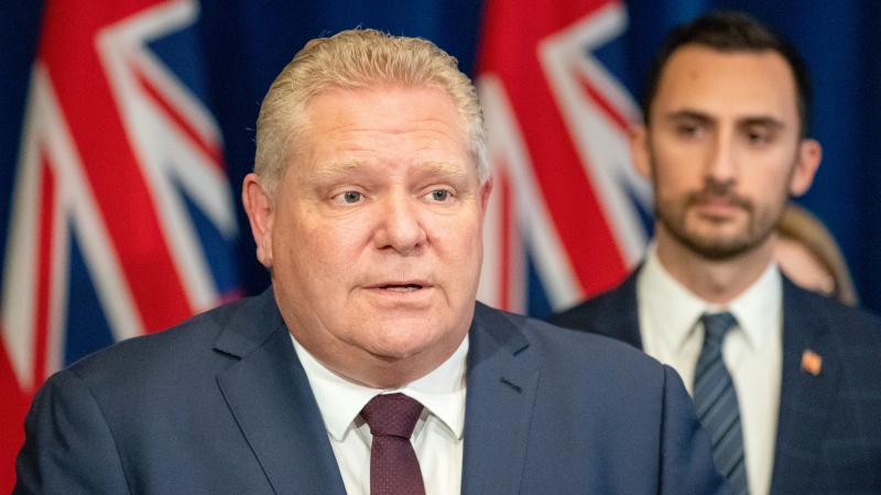 Ontario Premier Doug Ford speaks at a news conference as Education Minister Stephen Lecce listens at Queen's Park in Toronto on Friday, March 20, 2020. THE CANADIAN PRESS/Frank Gunn
