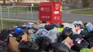 Garbage bags are seen near a clothing donation bin in Toronto on April 7, 2020. (CTV News Toronto) 