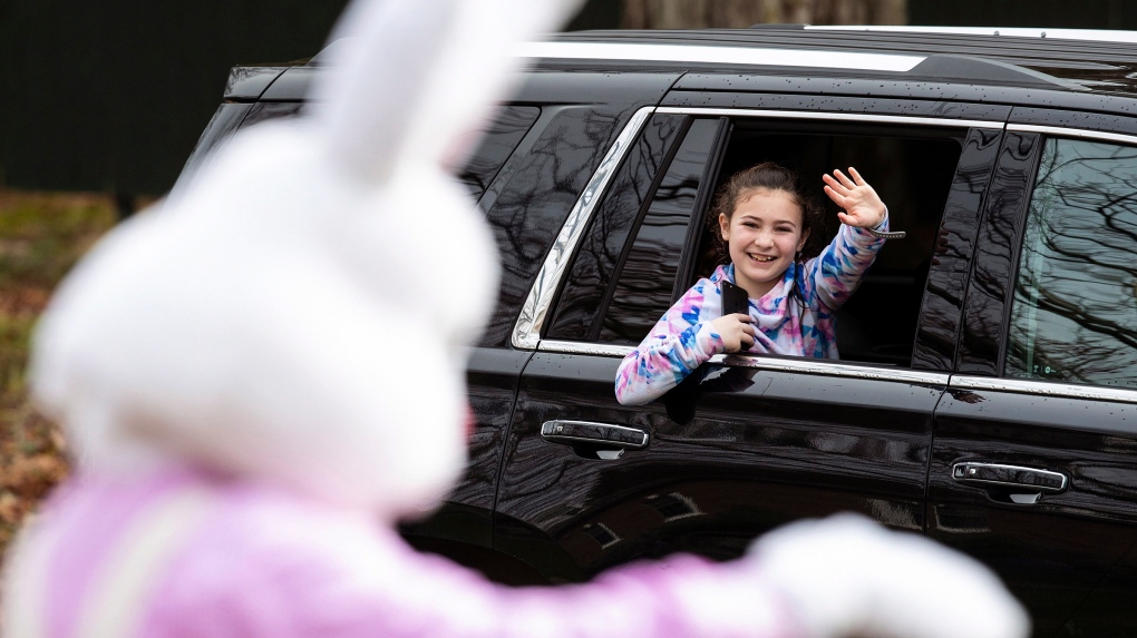 Easter Bunny waves to little girl in car