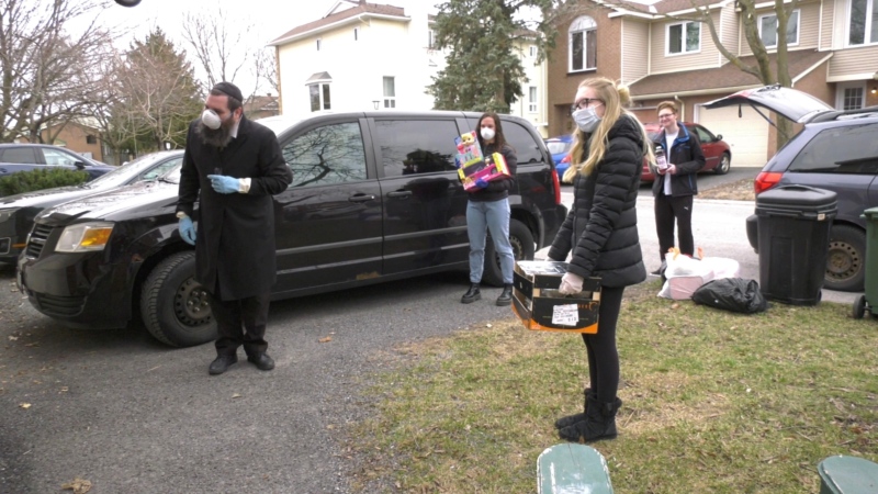 Ripple Effect team Sabrina Smith, Temima Silver and David Fogel along with Rabbi Chaim Mendelsohn deliver meals and gifts to families for Passover. April 8, 2020. (Tyler Fleming / CTV News Ottawa)