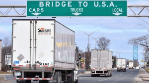 Transport trucks approach the Canada/USA border crossing in Windsor, Ont. on Saturday, March 21, 2020. THE CANADIAN PRESS/Rob Gurdebeke