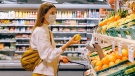 A woman wearing a mask is seen grocery shopping in this file photo. (Anna Shvets/Pexels)