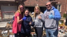 The Boyko family stands in front of the proceeds of their bottle drive in Kilworth, Ont. on Monday, April 20, 2020. (Jordyn Read / CTV London)