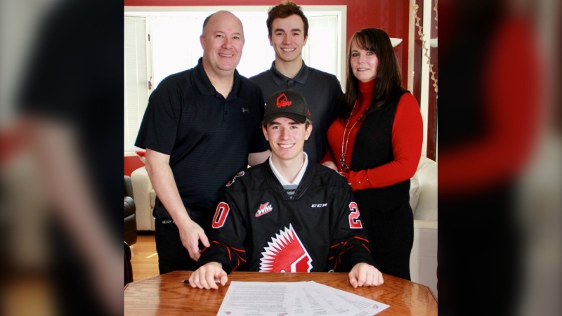 Brayden Yager, the Moose Jaw Warriors' third overall pick in the 2020 WHL Bantam Draft, signs his standard player agreement. (Source: Twitter/@MJWARRIORS)