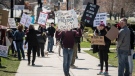 Demonstrators gather during a protest to end the shutdown due to COVID-19 at Queen's Park in Toronto on Saturday, April 25, 2020. THE CANADIAN PRESS/ Tijana Martin