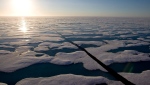 FILE - The midnight sun shines over the ice-covered waters near Resolute Bay at 1:30 a.m. as seen from the Canadian Coast Guard icebreaker Louis S. St-Laurent Saturday, July 12, 2008. (THE CANADIAN PRESS / Jonathan Hayward)