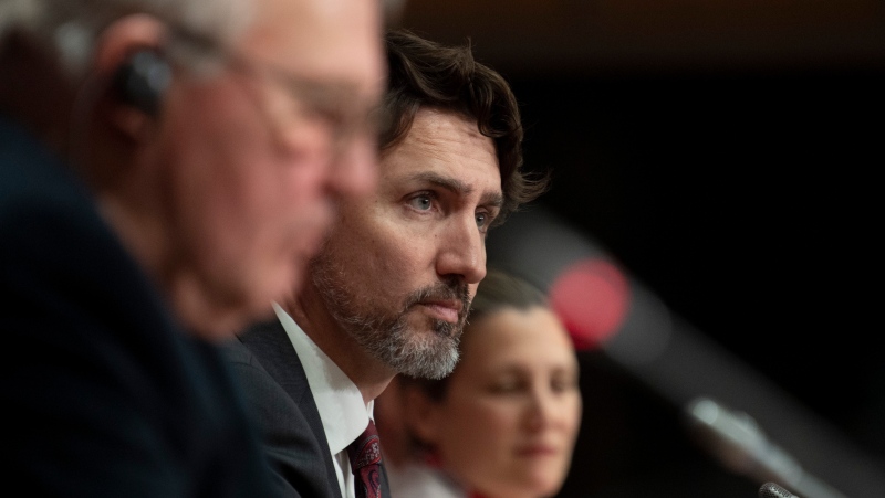 Prime Minister Justin Trudeau, centre, is seen during an announcement fon a ban on military style assault weapons during a news conference in Ottawa, Friday May 1, 2020. THE CANADIAN PRESS/Adrian Wyld