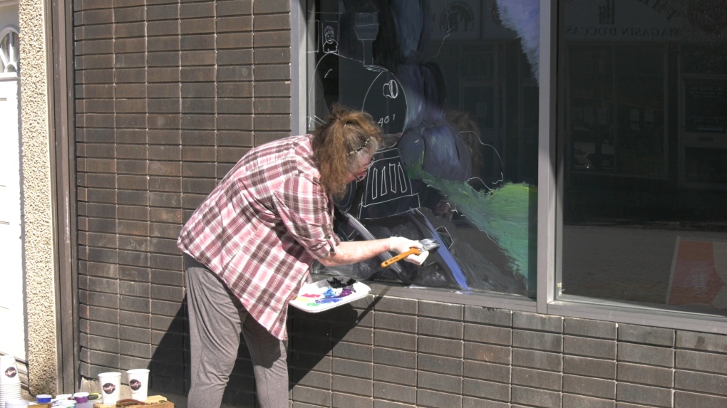 Windows in downtown Timmins being painted