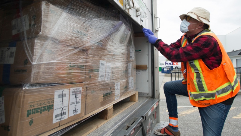In this file photo, a driver for Safecare B.C. secures a load of personal protective equipment in a truck for Safecare B.C. in Surrey, B.C. Tuesday, April 28, 2020. (THE CANADIAN PRESS / Jonathan Hayward)