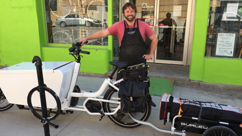 London Bicycle Café Owner Ben Cowie stands with a mobile bike repair kit in London, Ont. on Wednesday, May 6, 2020. (Bryan Bicknell / CTV London)