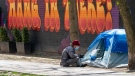 A nurse sits outside a tent at an encampment outside Sanctuary Ministries in Toronto on Monday, May 4, 2020. THE CANADIAN PRESS/Frank Gunn