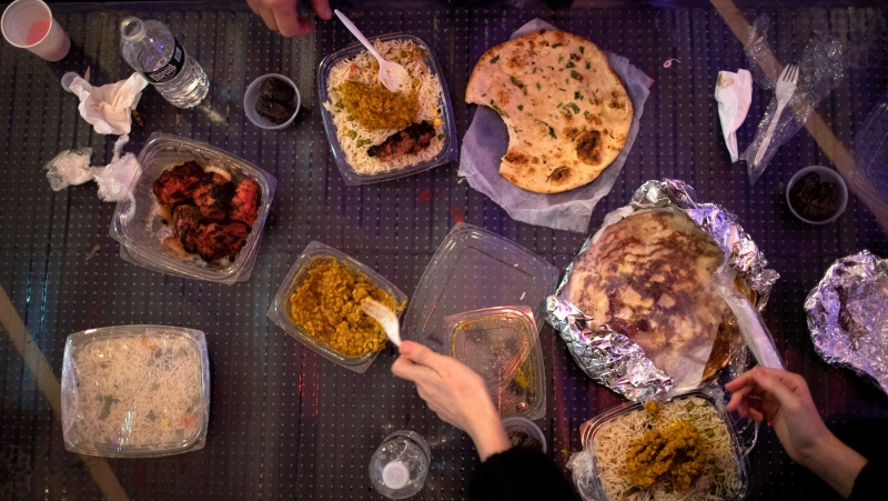 Volunteers from Muslims Giving Back end their day of fasting between volunteering at the Muslim Community Center in the Brooklyn borough of New York, on Friday, April 24, 2020. (AP Photo/Wong Maye-E)