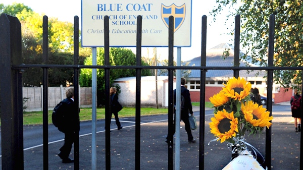 Flowers are attached to the gate of Blue Coat Church of England School in Coventry, England, on Tuesday Sept. 29, 2009. (AP / Rui Vieira, PA)