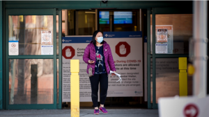 A woman leaves the Peter Lougheed Centre hospital in Calgary, Alta., Thursday, April 9, 2020, essential visitors are the only visitors permitted in Alberta hospitals as part of COVID-19 precautions. THE CANADIAN PRESS/Jeff McIntosh​