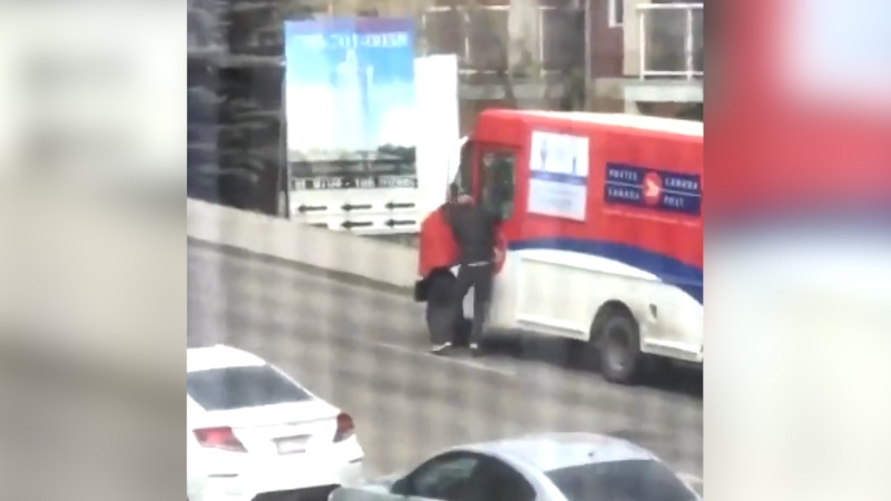 A still image from a video showing a man attacking an Edmonton Canada Post worker. (supplied)