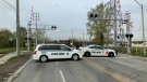 Police cruisers blocking Tecumseh Road West at the train tracks before the bend in Windsor, Ont., on May 15, 2020. (Chris Campbell / CTV Windsor)