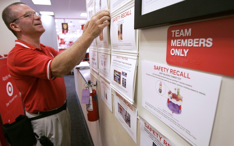 Target employee Bruce Noll adjusts safety recall notices on a bulletin board at a Target store in Richmond, Va., Tuesday, Aug. 14, 2007.  (AP / Steve Helber)