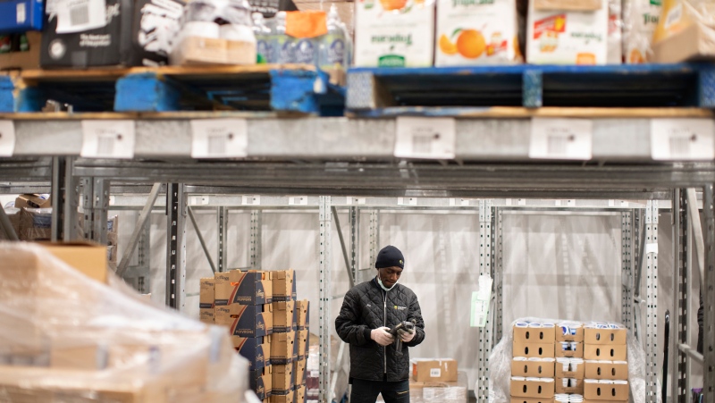 A staff member at the Daily Bread Food Bank stands in their cold storage unit at their warehouse in Toronto on Wednesday March 18, 2020. THE CANADIAN PRESS/Chris Young