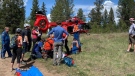 Search and rescue members carried the injured eight-year-old girl to an awaiting STARS Air Ambulance helicopter crew (Columbia Valley Search and Rescue)