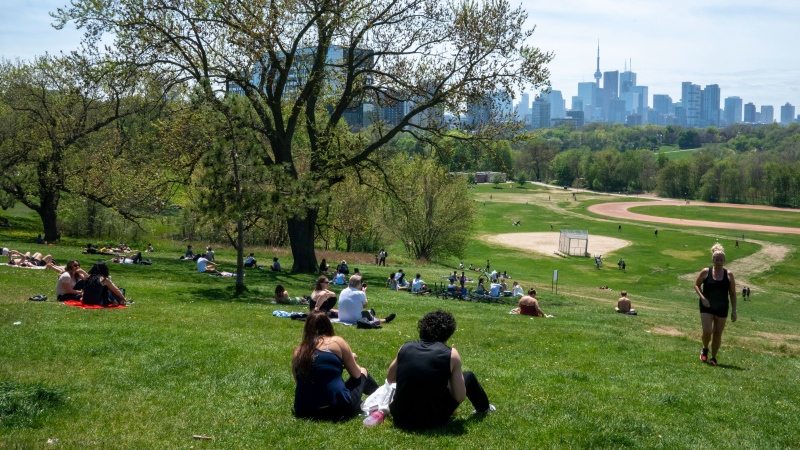 Park visitors soak up the sun in Toronto on Saturday, May 23, 2020. (THE CANADIAN PRESS / Frank Gunn)