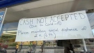 A sign posted on the window of Dairy Queen on Merivale Road instructing cashless transactions only. Ottawa, ON. May 26, 2020. (Tyler Fleming / CTV News Ottawa)