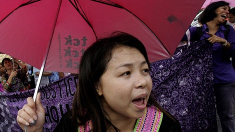 An activist chants slogans as she joins a protest outside the UN regional office, where delegates are holding talks on climate change Thursday, Oct. 1, 2009 in Bangkok, Thailand. (AP Photo/Apichart Weerawong)