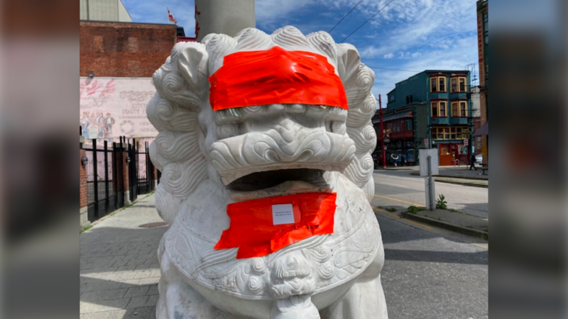Tape covers racist graffiti on the Chinatown lions statues in Vancouver in a photo posted by the City of Vancouver on May 29, 2020. (Twitter/City of Vancouver)