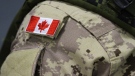 A Canadian flag patch is shown on the shoulder of a member of the Canadian forces at CFB Trenton, in Trenton, Ont., on Thursday, Oct. 16, 2014. (THE CANADIAN PRESS/Lars Hagberg)