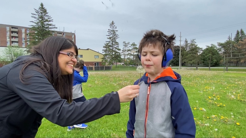 Tracey Abeysundera is helping her son Rayne Edwards blow a dandelion. June 2, 2020. Ottawa, ON. (Tyler Fleming / CTV News Ottawa)