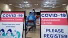 A man gets instructions for being tested for COVID-19 from a health care worker at a pop-up testing centre in Scarborough, Ont., on Friday, May 29, 2020. THE CANADIAN PRESS/Nathan Denette