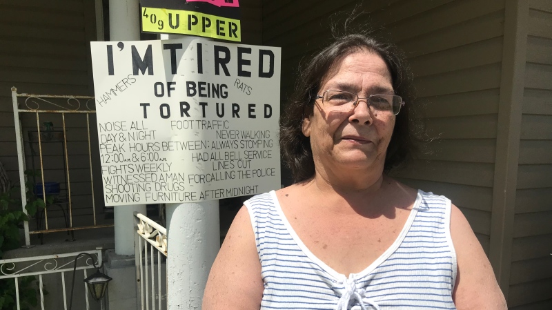 Michele Daly stands out front of her Chilver Road home in Walkerville, where she’s posted signs alerting neighbours to what she calls problems plaguing the neighbourhood on June 4, 2020. (Rich Garton / CTV Windsor)