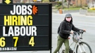 A woman checks out a jobs advertisement sign during the COVID-19 pandemic in Toronto on Wednesday, April 29, 2020. THE CANADIAN PRESS/Nathan Denette