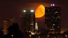 A waxing gibbous moon sets over the downtown skyline of Knoxville, Tenn., early Saturday, June 3, 2017, leading up to the June 9 Strawberry Moon. The Strawberry Moon, also referred to as a minimoon, is this year's smallest full moon orbiting some 250,000 miles away from Earth. (Calvin Mattheis/Knoxville News Sentinel via AP)