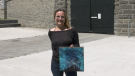 Artist Lisa Free stands with a canvas painting of the historic train tunnel in Brockville.  (Nathan Vandermeer/CTV News Ottawa)
