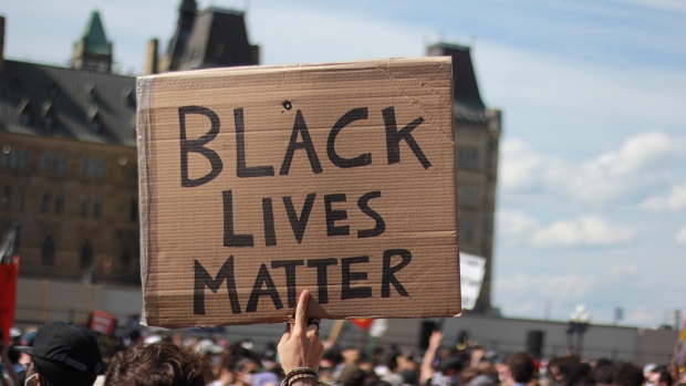 A protester in a crowd on Parliament Hill holds up a cardboard sign with the words 'Black Lives Matter'  during the 'No Justice Until Peace' march in Ottawa on June 5, 2020. (Skyler Walker/CTV Viewer)