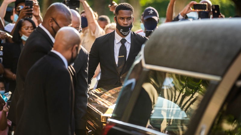 The casket of George Floyd is placed into a hearse at Fountain of Praise church in Houston, Monday, June 8, 2020. (Ricardo B. Brazziell/Austin American-Statesman via AP)