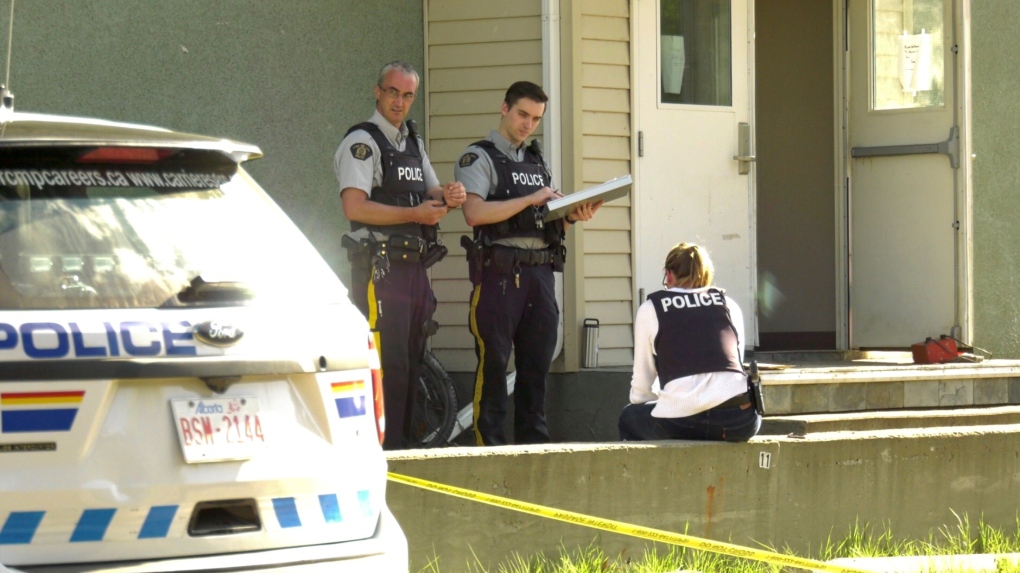 RCMP officers outside apartment building